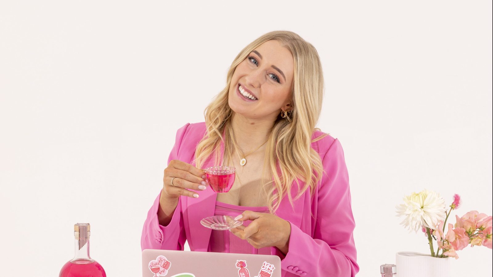 BABY Pink Gin founder Ellen Weigall with a cup, seated