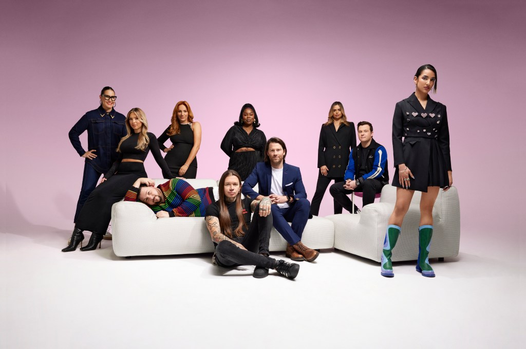 An image of multiple creators featured in Forbes Australia. Some are standing up, some are sitting or lying down on a white boucle couch. They are mostly wearing black outfits.