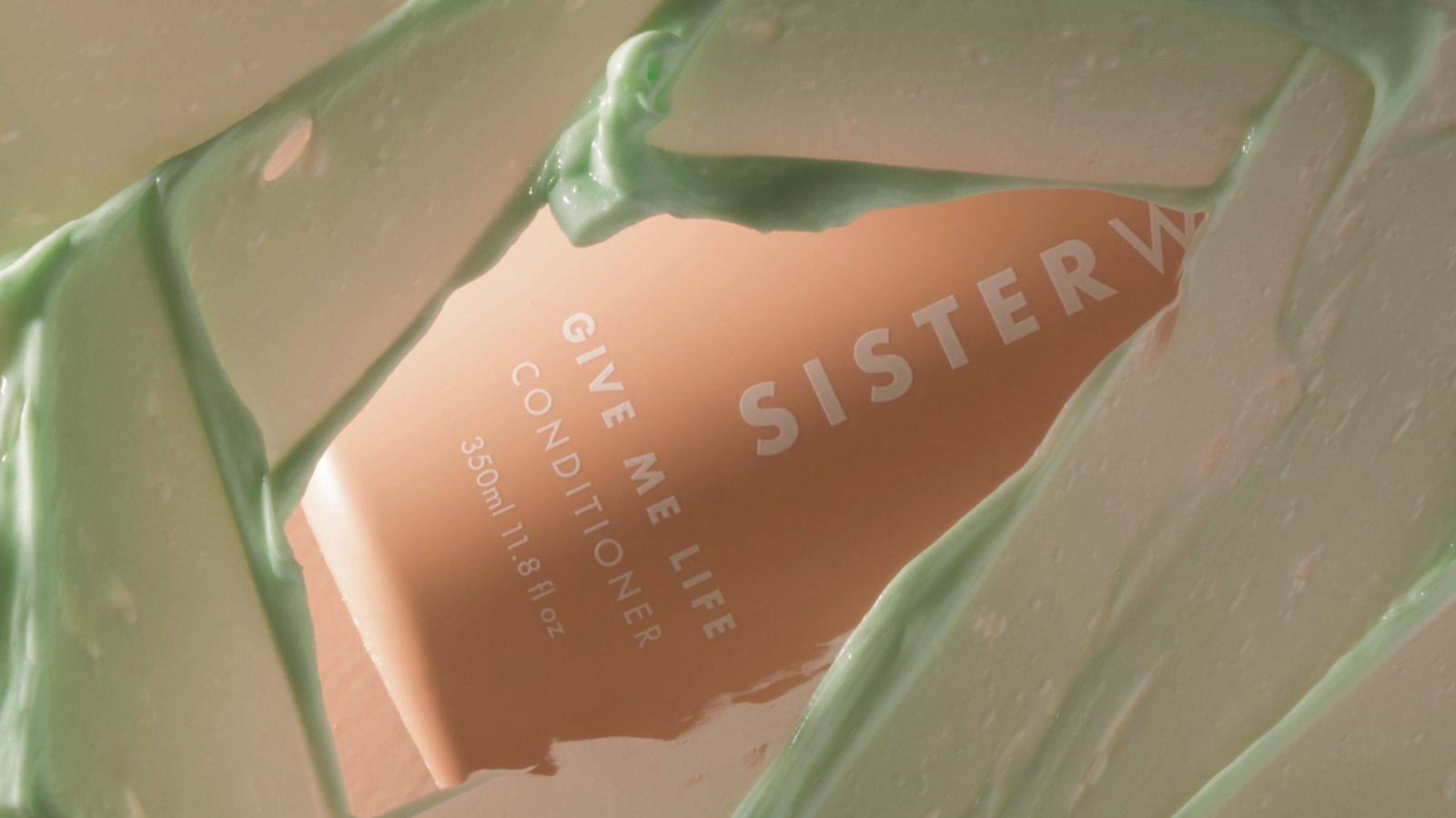 Sisterwould bottle of hair conditioner seen smeared with green conditioner product