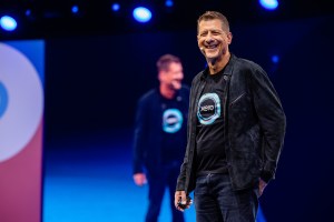 Xero boss Steve Vamos laughs while presenting on stage at Xerocon Sydney 2022.