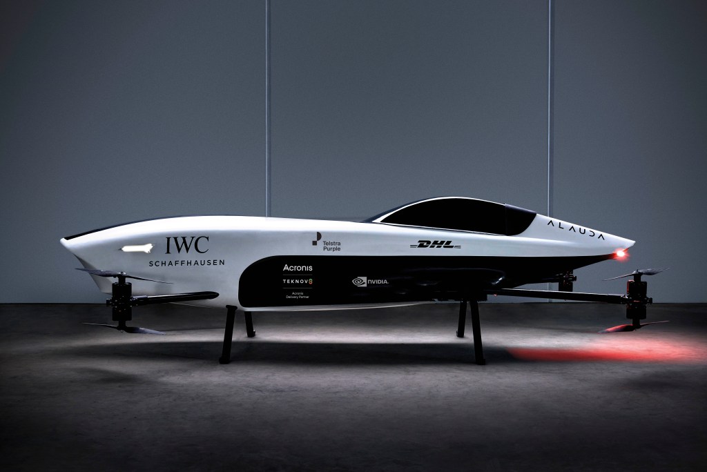 An Airspeeder flying drone. It is white, and has the company's sponsors on it.