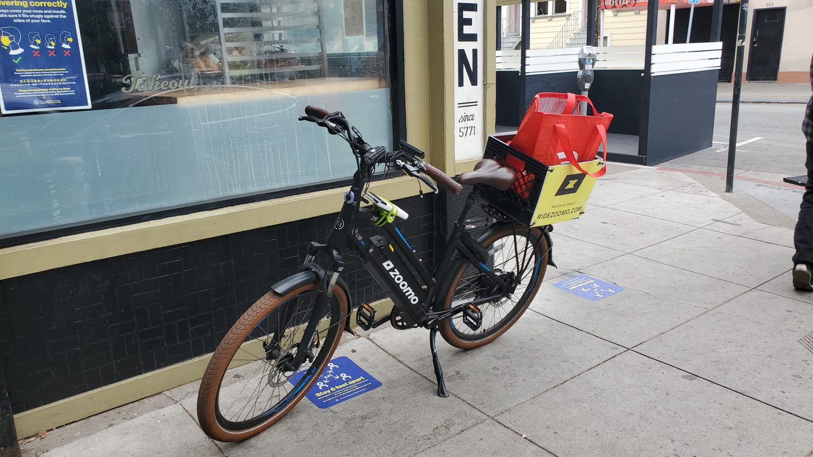 Zoomo e-bike parked in front of Wise Sons Delicatessen in the Mission District, San Francisco, California.