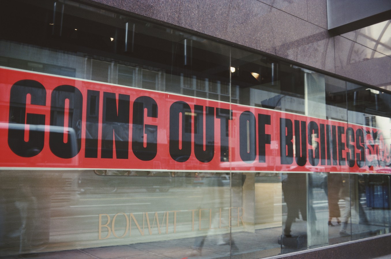 Shop front showing going out of business sign across window