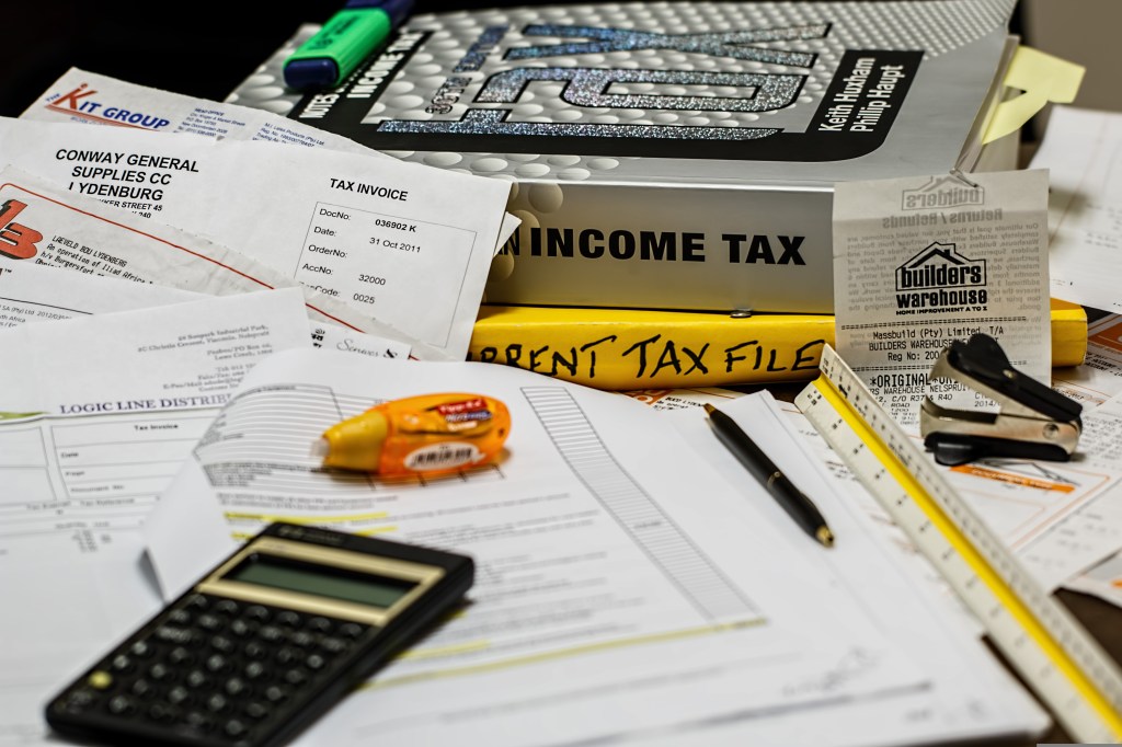 papers and calculator being used for tax review