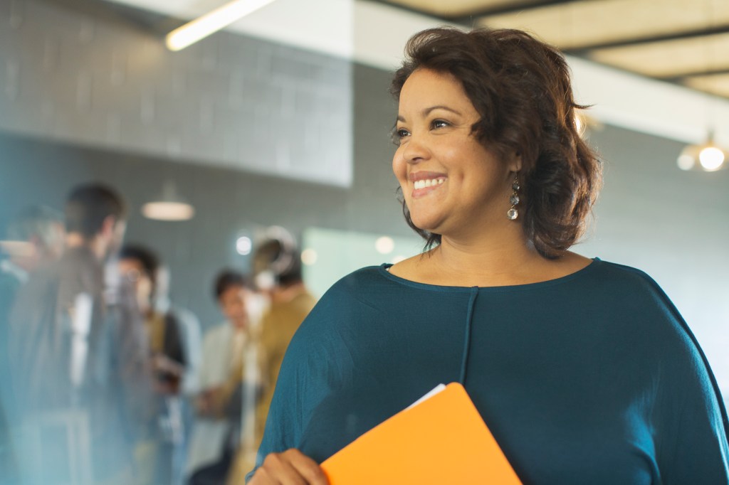 dark skinned woman holding folder