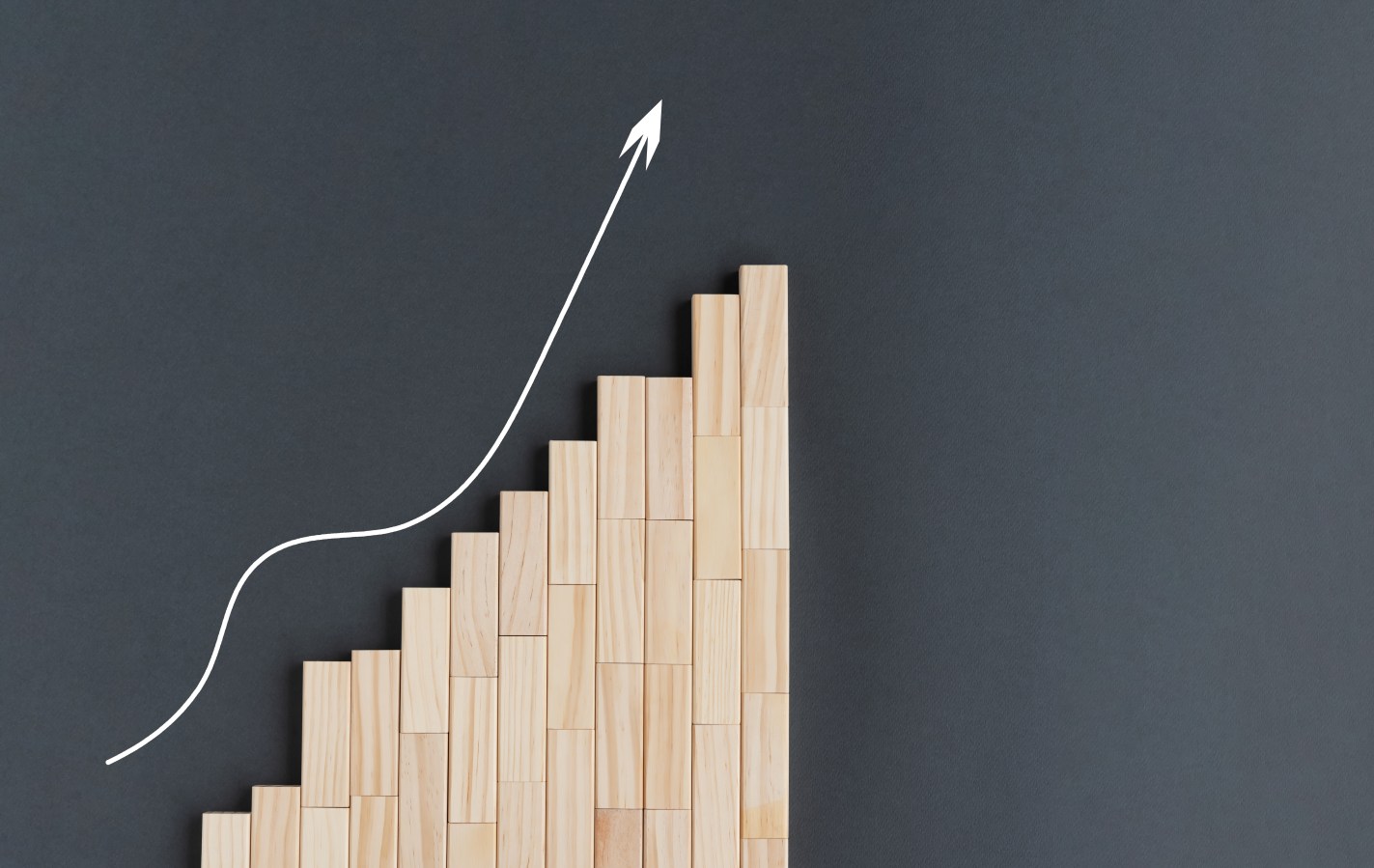 Arrow drawn heading up beside a bar chart with bars increasing