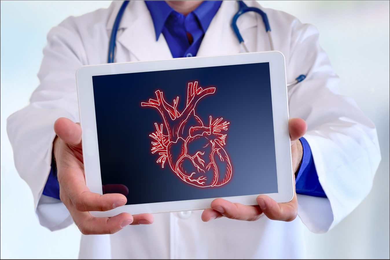 Doctor showing a heart on a tablet in front closeup