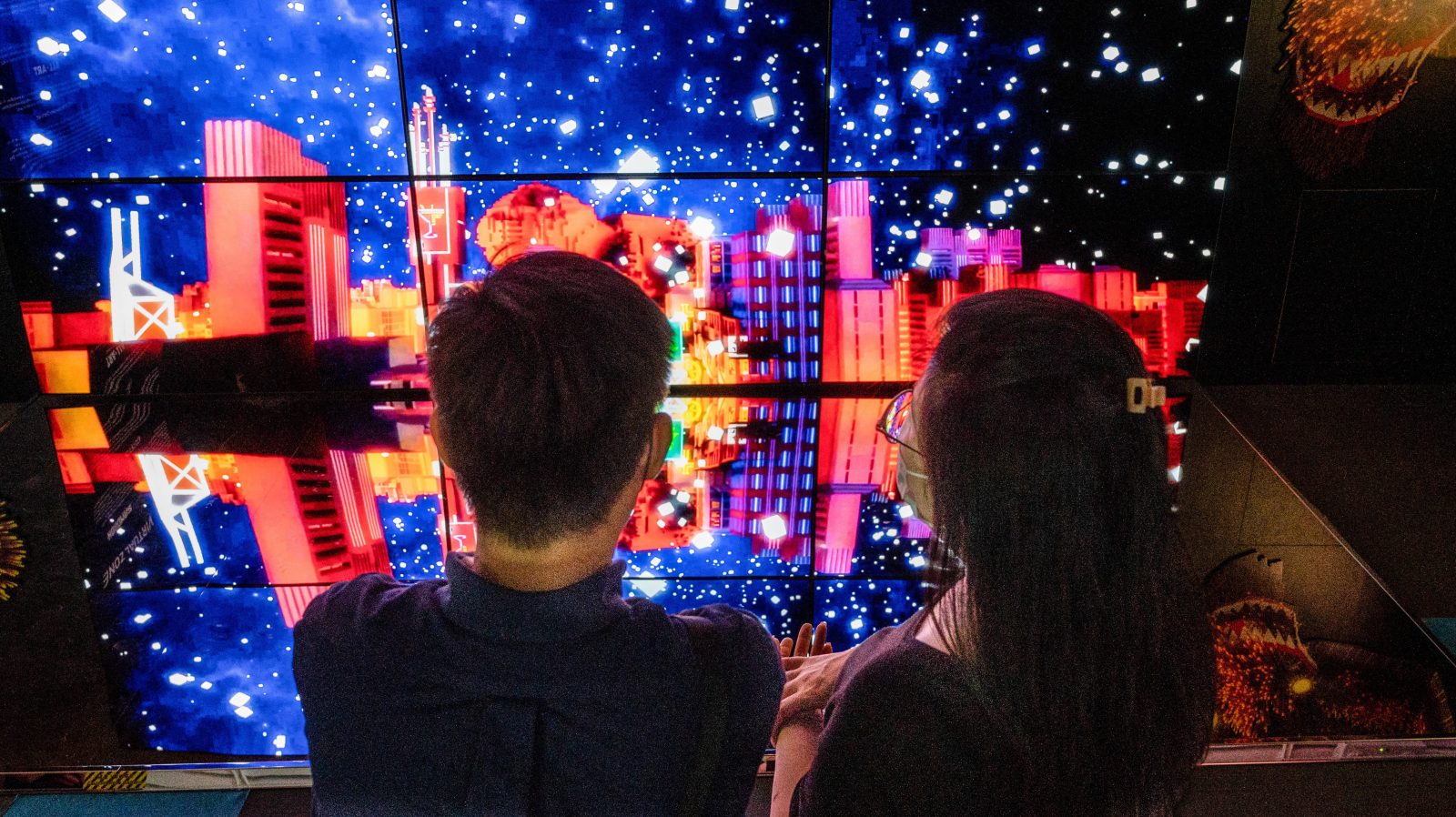 Visitors stand in front of an art installation by Index Game