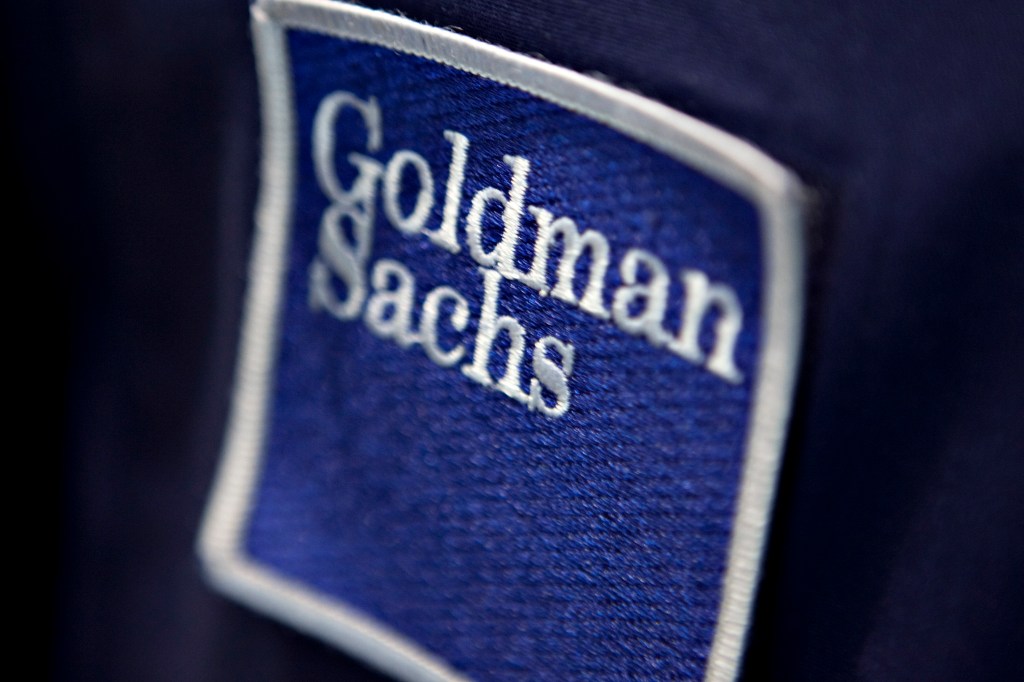 a cloth patch with Goldman Sachs stitched on it in white text on blue background