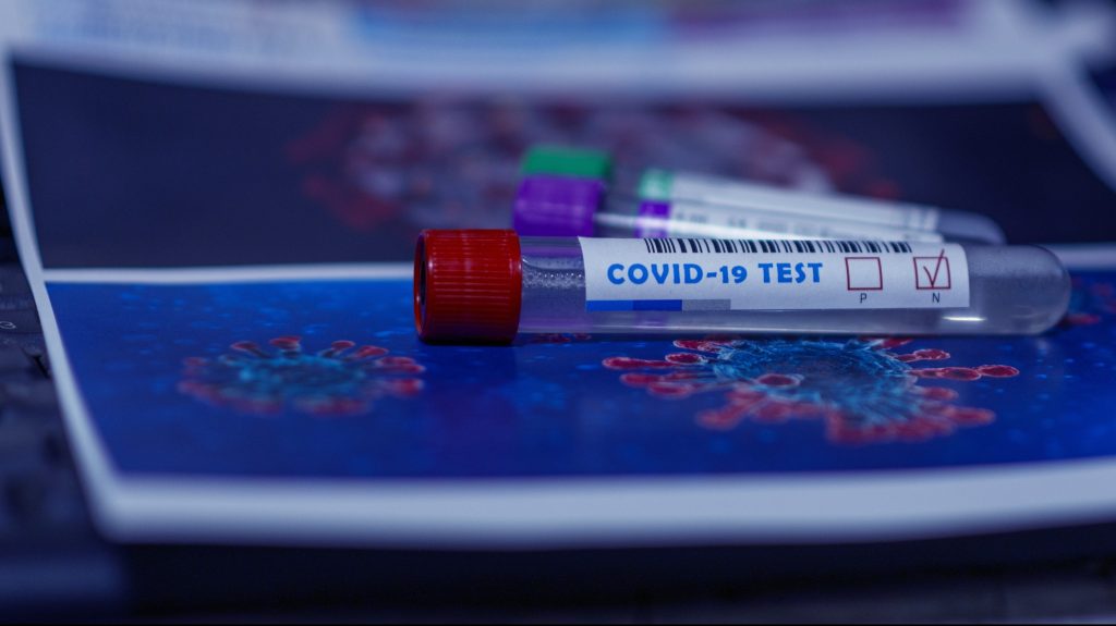 covid test vial on map printout