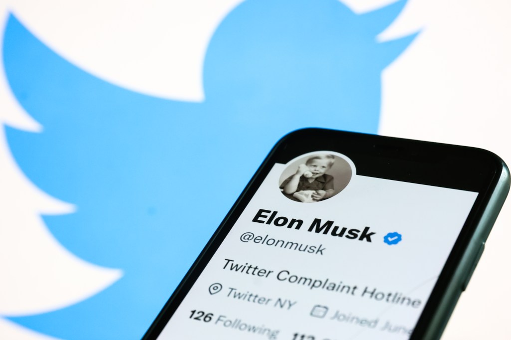 Elon Musk's Twitter account displayed on a phone screen and Twitter logo displayed on a laptop screen are seen in this illustration photo taken in Krakow, Poland on November 1, 2022
