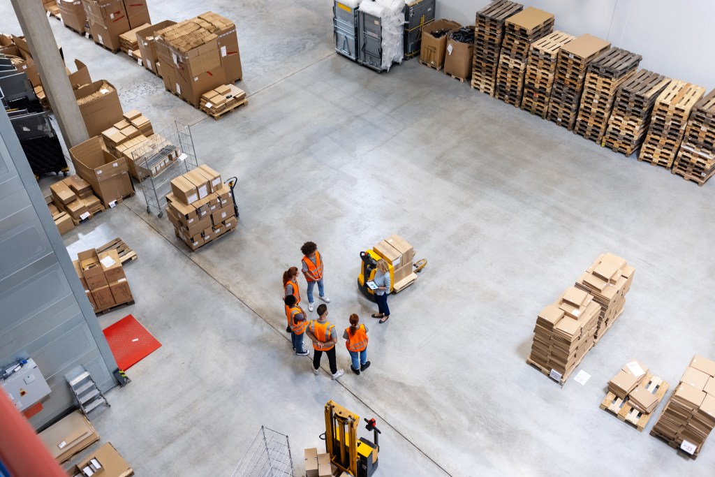 drone view of workers in logistics warehouse