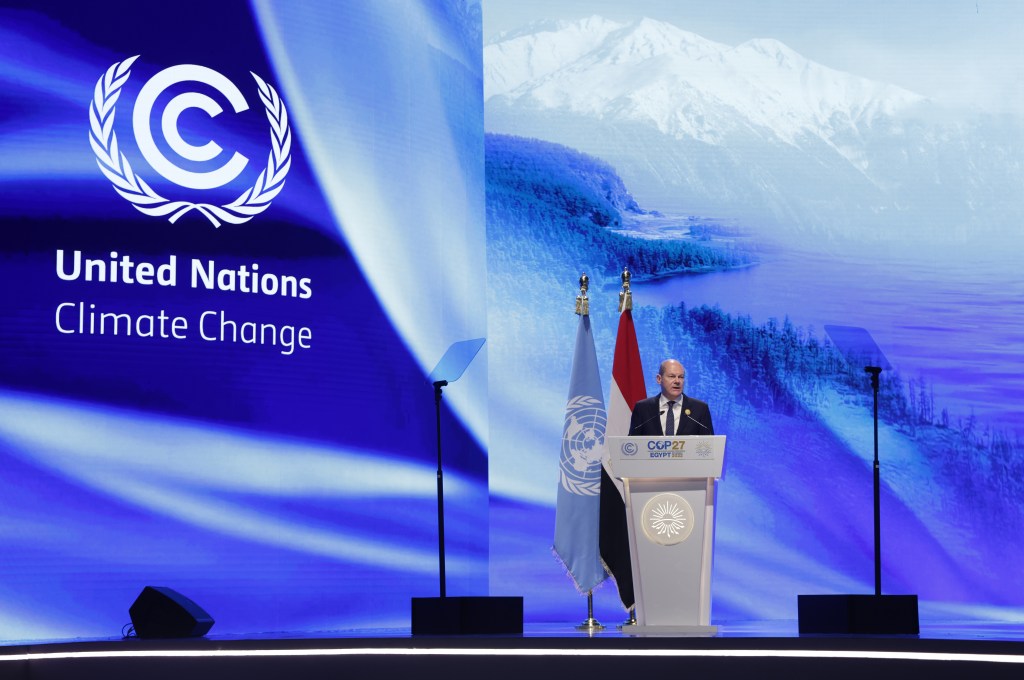 Cop 27 speaker with United Nations Climate Change signage 