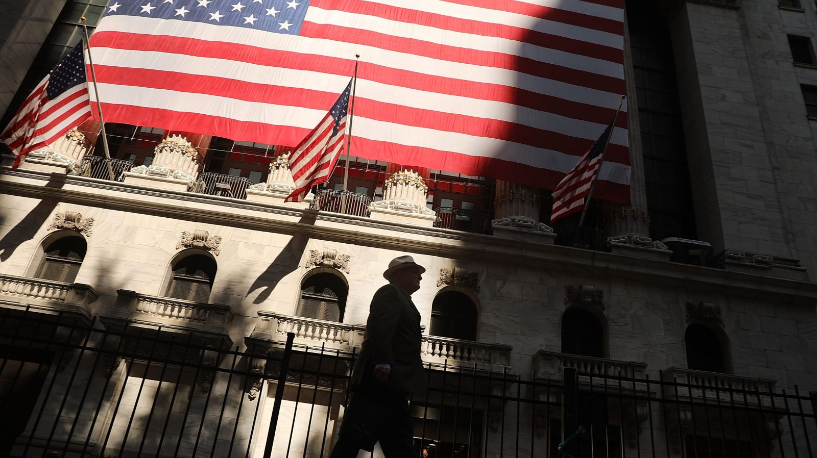 A man walks by the New York Stock Exchange (NYSE) on July 12, 2018 in New York City. As fears of a trade war eased with China, the Dow Jones Industrial Average rose 140 points in morning trading. (Photo by Spencer Platt/Getty Images)