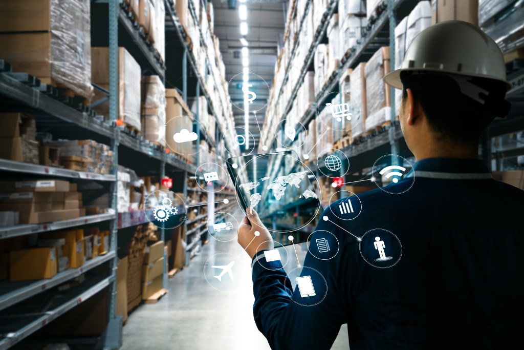 Man with tablet hand holding in factory storehouse with AR application for check order pick time in smart factory warehouse, technology interface global partner connection for Logistic Import Export background