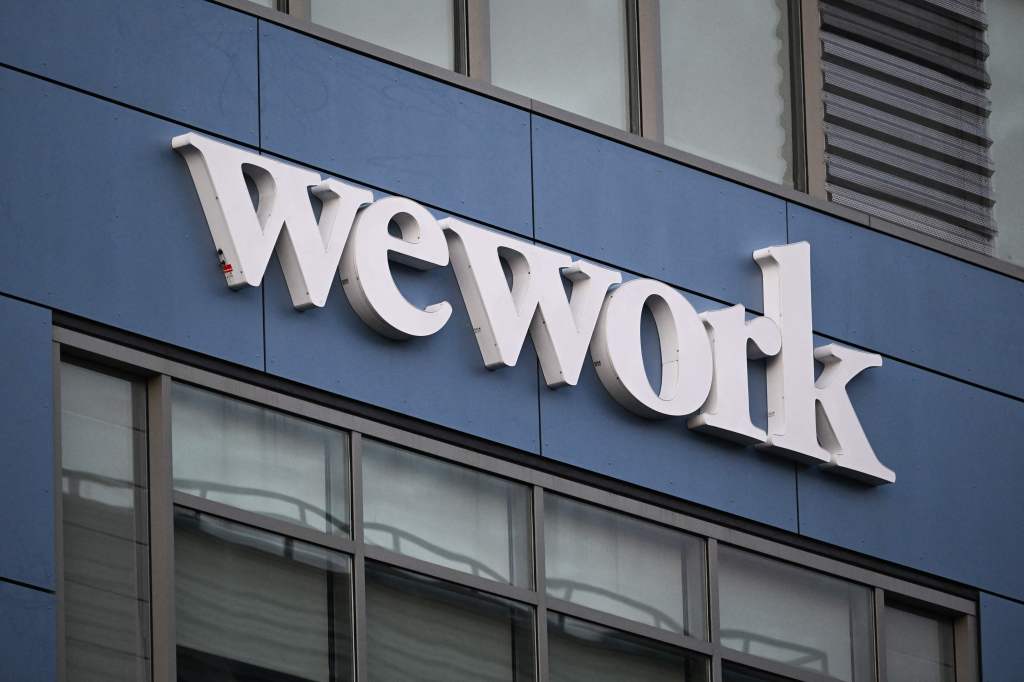 The WeWork logo is displayed outside of a shared commercial office space building in Los Angeles, California on August 8, 2023. Embattled office-sharing firm WeWork on August 8 warned US regulators that it is worried about its survival. Citing financial losses, cash needs, and a drop in memberships, WeWork said in a filing with the Securities and Exchange Commission (SEC) that "substantial doubt exists about the company's ability to continue as a going concern." (Photo by Patrick T. Fallon / AFP) (Photo by PATRICK T. FALLON/AFP via Getty Images)