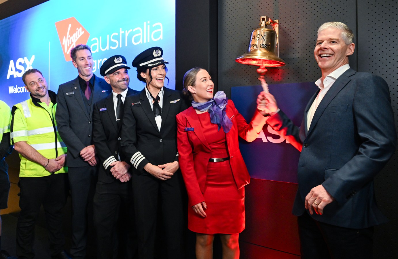 Dave Emerson, CEO Virgin Australia (R) with Virgin Australia crew as they ring the ASX bell on Tuesday. Image: Getty