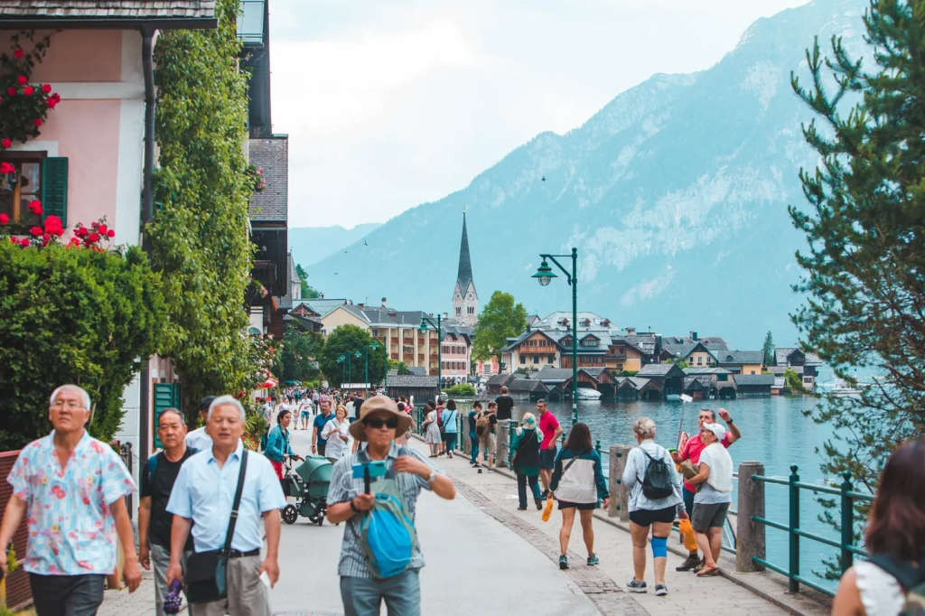 Tourists crowd the lakeside streets of Hallstatt, Austria—a fairytale village grappling with overtourism. The town temporarily installed a “selfie fence” to reduce congestion at popular viewpoints.
getty