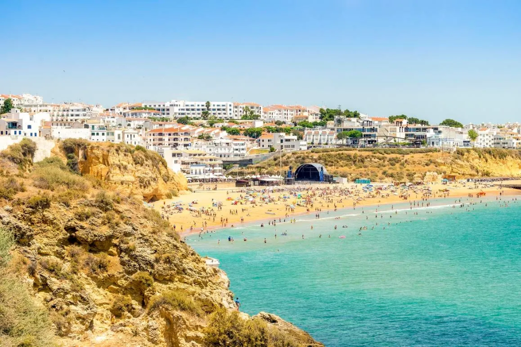 A busy beach day in Albufeira, Portugal. As tourist numbers soar, coastal towns like this are enforcing stricter rules—banning public drinking, limiting noise and imposing fines for walking around in swimwear.
getty