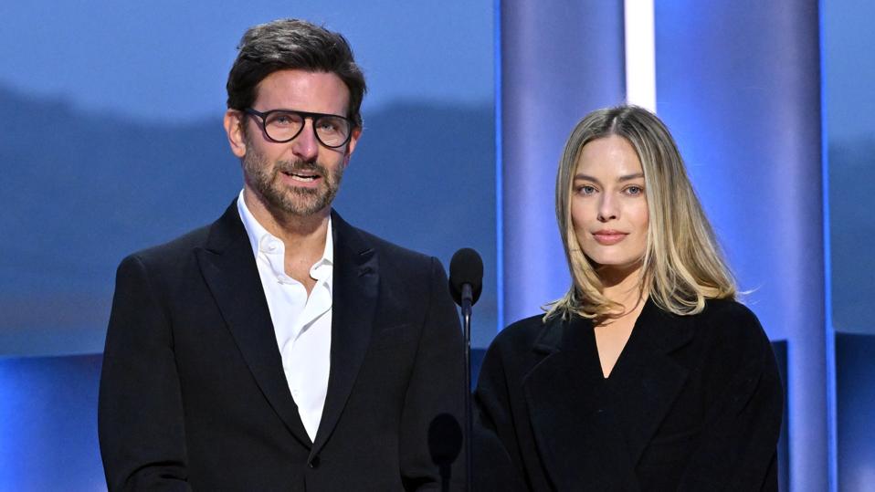 Bradley Cooper and Margot Robbie speak onstage during the 10th Breakthrough Prize Ceremony at the Academy of Motion Picture Arts and Sciences on April 13, 2024.